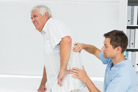 Elderly patient with lower back pain at the doctor